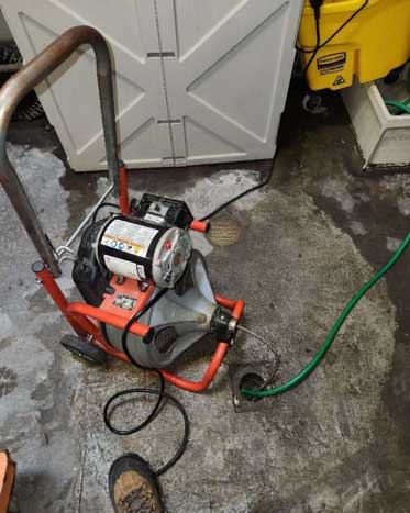 Cleaning a drain with a drain cleaning snake in Houston TX.