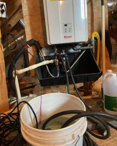 Yearly service of a tank less water heaters in progress.