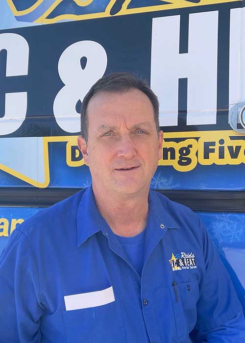 Ac repair in Conroe TX technician Greg standing in front of a Reids AC & Heat van.