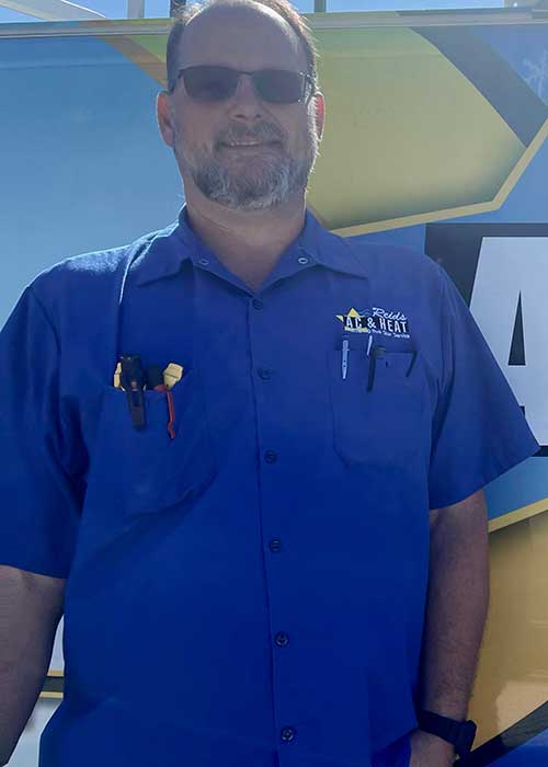 AC repair in Cypress TX technician Chris standing outside of a Reids AC & Heat van.